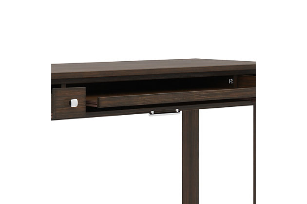 Clean lines and a dark gray finish give this contemporary writing desk a fresh style awakening. Its large surface area is ideal for a monitor, laptop or tablet and leaves enough room for paper, books and other writing accessories. It features a pull-out keyboard tray behind a flip down drawer front plus two side drawers for additional storage space. Ideal for home office or living room settings where it can be used in place of a console or sofa table.Handcrafted of pine wood | Hand-finished with a farmhouse brown finish and a protective nitrocellulose lacquer | 2 side storage drawers with metal drawer glides and brushed nickel-tone pulls | Flip down central drawer front with internal keyboard tray | Elegant square legs and framed sides | Assembly Required