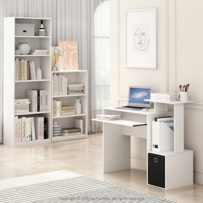 Living room setup showing two white bookshelves filled with books and decor, desk setup nearby
