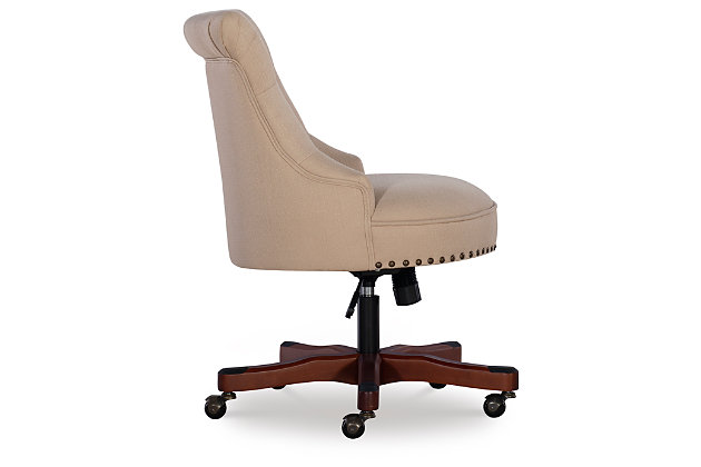 Work comfortably in the vintage beauty of this plush office chair. Upholstered in a beige rice fabric, this seat has a beautiful button tufted back with burnished brass-tone nailheads. A cherry-tone finished wood base has metal casters for ease of mobility. This chair is sure to bring eye-catching interest and function to any work area—perfect for a home work space or the office.Made of pine wood and rubberwood | Cherry-tone base | Metal casters | Polyester upholstery | Button-tufted back | CA fire foam cushion | Gas lift mechanism for seat height adjustability with BIFMA standard | Burnished brass-tone nailhead trim | Some assembly required