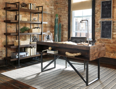 For fans of urban industrial design, the Starmore desk steals the show. Its top is crafted with a mix of acacia veneer and wood beautified with an oiled walnut-tone finish. A sleek tubular metal frame and linear, large-scale pulls pull it all together. The cutout shelf on the desk’s front side incorporates added dimension.Top made with wood, acacia veneers and engineered wood | Dark bronze-tone tubular metal legs and pulls | 3 smooth-gliding drawers with dovetail construction | Assembly required | Estimated Assembly Time: 15 Minutes