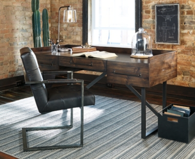 For fans of urban industrial design, the Starmore desk steals the show. Its top is crafted with a mix of acacia veneer and wood beautified with an oiled walnut-tone finish. A sleek tubular metal frame and linear, large-scale pulls pull it all together. The cutout shelf on the desk’s front side incorporates added dimension.Top made with wood, acacia veneers and engineered wood | Dark bronze-tone tubular metal legs and pulls | 3 smooth-gliding drawers with dovetail construction | Assembly required | Estimated Assembly Time: 15 Minutes