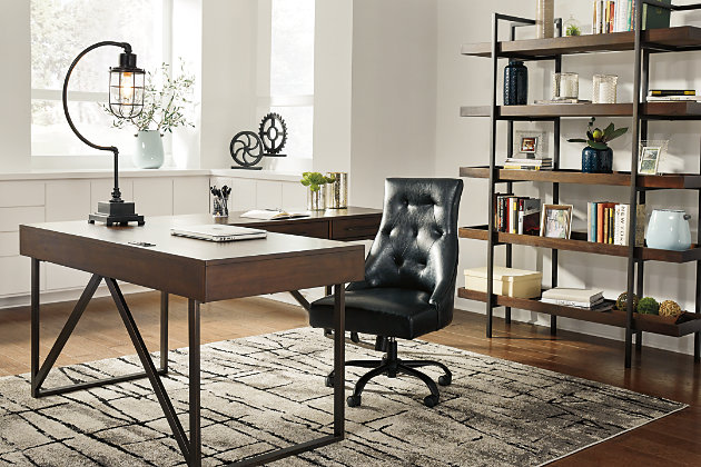 For fans of urban industrial design, the Starmore L-shaped desk steals the show. Top is crafted with a mix of acacia veneer and wood beautified with an oiled walnut-tone finish. Incorporation of sleek tubular metal frame and linear, large-scale pulls pull it all together. Includes desk and desk return | Top made of acacia veneers, wood and engineered wood in oil-rubbed walnut finish | Metal base and hardware in bronze-tone finish | Return with 2 smooth-gliding drawers | Desk with drop-front drawer | Built-in power station with 2 AC electrical plug-ins and 2 USB slots | Power cord included; UL-listed | Assembly required | Estimated Assembly Time: 50 Minutes