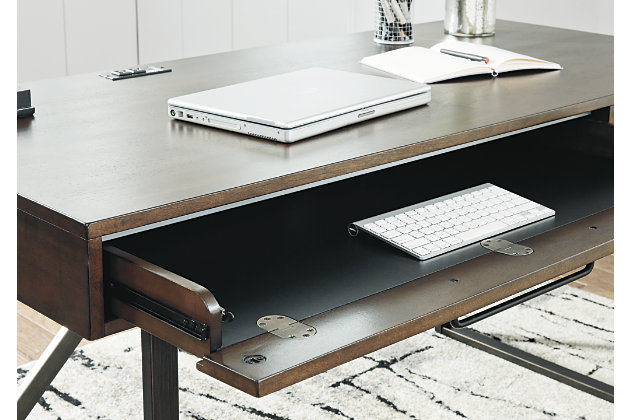 For fans of urban industrial design, the Starmore desk steals the show. Top is crafted with a mix of acacia veneer and engineered wood beautified with an oiled walnut-tone finish. Incorporation of sleek tubular metal frame and linear, large-scale pulls pull it all together.Top made of acacia veneers, solid wood components and engineered wood in oil-rubbed walnut finish | Metal base and hardware in bronze-tone finish | Top made of acacia veneers, wood and engineered wood in oil-rubbed walnut finish | Metal base and hardware in bronze-tone finish | Drop-front keyboard tray/drawer, plus smooth-gliding drawer | Built-in power station with 2 AC electrical plug-ins and 2 USB slots | Power cord included; UL Listed | Assembly required | Estimated Assembly Time: 15 Minutes