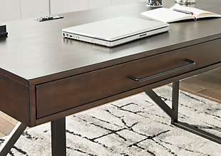 For fans of urban industrial design, the Starmore desk steals the show. Top is crafted with a mix of acacia veneer and engineered wood beautified with an oiled walnut-tone finish. Incorporation of sleek tubular metal frame and linear, large-scale pulls pull it all together.Top made of acacia veneers, solid wood components and engineered wood in oil-rubbed walnut finish | Metal base and hardware in bronze-tone finish | Top made of acacia veneers, wood and engineered wood in oil-rubbed walnut finish | Metal base and hardware in bronze-tone finish | Drop-front keyboard tray/drawer, plus smooth-gliding drawer | Built-in power station with 2 AC electrical plug-ins and 2 USB slots | Power cord included; UL Listed | Assembly required | Estimated Assembly Time: 15 Minutes