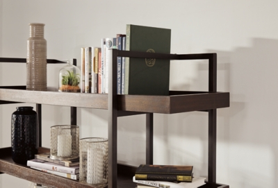 If you’re a fan of urban industrial design, it’s easy to see why the Starmore bookcase is a bestseller. The metal frame is sleek, sculptural and ultra modern. Beautified with an oiled walnut-tone finish, five gallery shelves stack up to great form and function.Shelves made with wood, acacia veneers and engineered wood | Metal frame with bronze-tone finish | 5 fixed shelves | Excluded from promotional discounts and coupons | Estimated Assembly Time: 30 Minutes