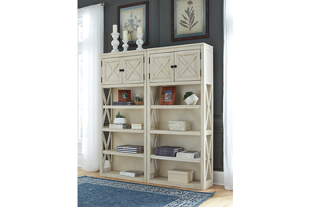Whether your style is farmhouse fresh, shabby chic or country cottage, you'll find the Bolanburg tall bookcase works on so many levels. A gently distressed antiqued white finish and crossbuck detailing give this striking bookcase distinctive charm. Trio of shelves and double-door cabinet provide plenty of storage in a space-efficient way.Made of veneers, wood and engineered wood | Antiqued white finish | Gentle distressing | 3 shelves (2 adjustable and 1 fixed) | Double door cabinet | Estimated Assembly Time: 45 Minutes