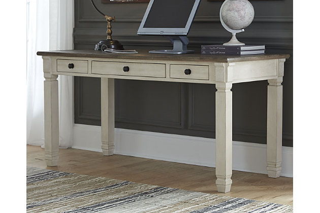 Whether your style is farmhouse fresh, shabby chic or country cottage, you'll find the Bolanburg desk works on so many levels. Two-tone, gently distressed finish of weathered oak over antique white doubles up on character that’s enhanced with a plank-effect top. Trio of smooth-gliding drawers provide handy storage.Made of veneers, wood and engineered wood | Two-tone finish (weathered oak over antique white) | Plank-style top | 3 smooth-gliding drawers | Black faceted hardware | Assembly required | Estimated Assembly Time: 15 Minutes