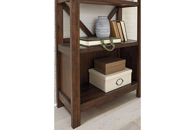 Leaning toward a casually cool look with a touch of rustic industrial flair? The Baldridge bookcase takes a fresh stance on style. Clean-lined profile with crossbuck back is complete with saw marks for distinctive character.Made of veneers, wood and engineered wood | Rustic, warm brown finish | Subtle saw mark distressing | 4 shelves; 2 of which are adjustable | Assembly required | Estimated Assembly Time: 45 Minutes