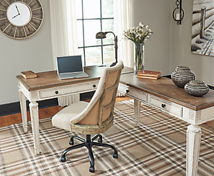 Elevating the art of traditional cottage styling, the Realyn L-shaped desk is your heavenly home office realized. Two-tone finish combines chipped white with distressed wood tone tops for added charm. Framed drawer fronts, decorative corbels and elegantly turned and tapered legs add refinement, while dark bronze-tone knobs lend a classic touch. Spring lift top raises the surface to a comfortable standing position, for a healthy alternative. Built for looks and productivity, the built-in power supply and dual USB ports keep your devices close at hand and ready to go.Includes desk and desk return  | Made of wood, engineered wood and veneers, with cast resin components | Antiqued two-tone finish | Return with 2 smooth-gliding drawers with dovetail construction | Desk with spring lift top and drop-front drawer | Return with cutout for cord management | Dark bronze-tone finished metal hardware | 2 AC electrical plug-ins and 2 USB slots | Power cord included; UL-listed | Assembly required | Estimated Assembly Time: 50 Minutes
