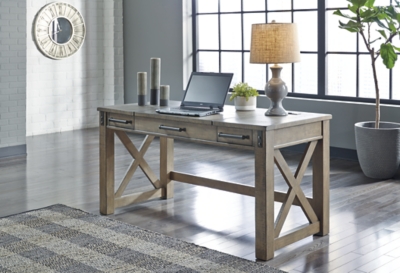 Crafted with pine veneers and wood treated to a distressed gray finish, the Aldwin lift top desk is rustic farmhouse living at its best. Crossbuck styling adds striking flair, while metal industrial brackets incorporate an industrial twist. Elevating the functionality of this lift top desk all the more: two smooth-gliding drawers and conveniently placed AC power/USB plug-ins.Made of pine veneers, pine wood and engineered wood | Distressed gray finish | Metal bracket accents | 2 smooth-gliding drawers with dovetail construction | 2 electrical outlets and 2 USB charging ports | Power cord included; UL Listed | Spring lift top | Assembly required | Estimated Assembly Time: 30 Minutes