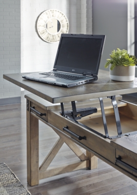 Crafted with pine veneers and wood treated to a distressed gray finish, the Aldwin lift top desk is rustic farmhouse living at its best. Crossbuck styling adds striking flair, while metal industrial brackets incorporate an industrial twist. Elevating the functionality of this lift top desk all the more: two smooth-gliding drawers and conveniently placed AC power/USB plug-ins.Made of pine veneers, pine wood and engineered wood | Distressed gray finish | Metal bracket accents | 2 smooth-gliding drawers with dovetail construction | 2 electrical outlets and 2 USB charging ports | Power cord included; UL Listed | Spring lift top | Assembly required | Estimated Assembly Time: 30 Minutes