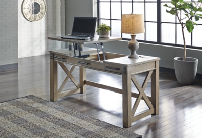 Crafted with pine veneers and wood treated to a distressed gray finish, the Aldwin lift top desk is rustic farmhouse living at its best. Crossbuck styling adds striking flair, while metal industrial brackets incorporate an industrial twist. Elevating the functionality of this lift top desk all the more: two smooth-gliding drawers and conveniently placed AC power/USB plug-ins.Made of pine veneers, pine wood and engineered wood | Distressed gray finish | Metal bracket accents | 2 smooth-gliding drawers with dovetail construction | 2 electrical outlets and 2 USB charging ports | Power cord included; UL Listed | Spring lift top | Assembly required | Estimated Assembly Time: 30 Minutes