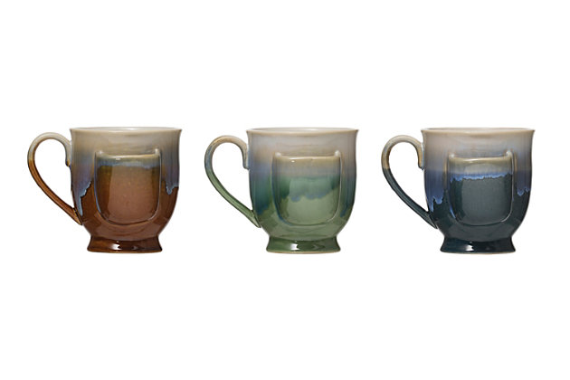 Tea happy when serving guests with this 3-piece mug set. These magnificent mugs in a trio of colors are brilliantly designed with a side slot for holding tea bags. How civilized.Set of 3 | Made of stoneware/ceramic | Tea bag pocket on each mug | Reactive glaze finish | Each mug is 5-1/4" l x 4-3/4" w x 4-1/4" h