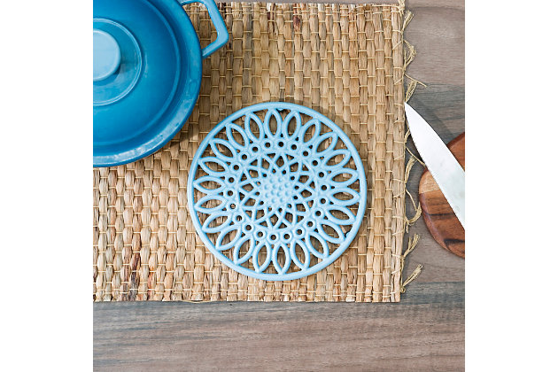 Add a touch of botanical bliss to your kitchen with the help of this Sunflower inspired trivet. Crafted from heavy weight cast iron, its  durable construction allows it to withstand high temperatures to up 347 degrees Fahrenheit.  Its ornate, sunflower pattern doubles as stylish tableware and  makes it both a beautiful addition to the kitchen and dining room for both everyday use and special occasion.   Use this metal trivet to keep scratches and excessive heat from damaging your surfaces.  Or use as decorative trivet to serve up a piping hot festive dish during the holidays.Perfect for keeping counters and tables free from scratches and heat: an elegant replacement for those old pot holders and towels, this trivet keeps your counter and dining table safe from scorching hot serving dishes and meals. | Elevated to keep hot dishes from directly touching the table and countertop: the base is raised to ensure that no heat will have any contact with your home’s surfaces. Perfect to display on the counter, table, kitchen island, and never worry about damage | Cheerful sunflower design: ornate sunflower detailing adds a cheerful touch to the kitchen | High quality design: made of heavy duty cast iron, it features a thick,  durable enamel coating that resists rust.