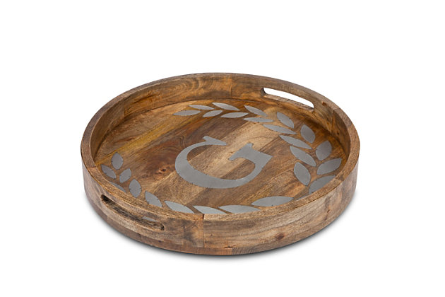 Add a personalized touch to every meal with the unique Heritage Collection metal inlay monogram round tray! Crafted of fine grained mango wood with laurel leaf metal inlays, our round tray is almost too attractive to cover with food or utensils! A 20-inch diameter gives you ample room to serve afternoon tea or after dinner coffee in elegant style. Handles are cut into the wood, for ease in  carrying from room to room. This rustic looking tray is a gorgeous gift for anyone who loves to serve food or beverages in style.Add a personalized touch to every meal with the unique heritage collection metal inlay monogram round tray! | Bring coffee to the table with vintage european style with this 20-inch diameter wooden tray | High quality mango wood is medium brown and finely grained, selected  for durability and long use life | Hand wipe with mild soapy washcloth and dry with a soft cloth | Handles are cut into the wood for form and function allowing you to easily carry your tray from room to room