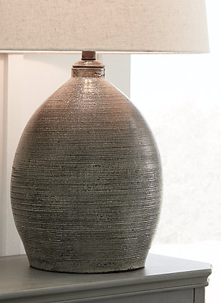 Set the scene for earthy elegance with the Joyelle table lamp with terracotta base. Whether your decor is modern or eclectic, what a complement to your bedroom, living room or office.Made of terracotta with fabric modified drum shade | Distressed gray finish | 3-way switch | 1 type A bulb (not included), 150 watts max or CFL 25 watts max; UL Listed | Due to the handcrafted nature of this product, some variations may occur | Minor assembly | Estimated Assembly Time: 15 Minutes