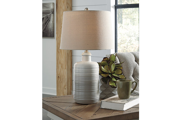 Wowing with shades of taupe and white, the Marnina table lamp lights up our world. The glazed, textural base encompasses casual-cool beauty beside any sofa or bed—what a well-rounded pair.Made of white and taupe glazed ceramic with modified drum shade | 3-way switch | 1 type A bulb (not included); 100 watts max or CFL 23 watts max; UL Listed | Clean with a soft, dry cloth | Assembly required | Estimated Assembly Time: 15 Minutes