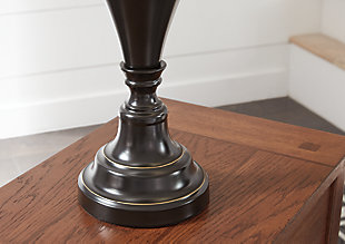 Delightfully turned pedestal base gives the Darlita table lamp a sense of easy elegance. Dark bronze-tone metal is a simply stylish counterpoint.Made of metal with fabric hardback shade | 3-way switch | 1 type A bulb (not included); 150 watts max or CFL 25 watts max; UL Listed | Clean with a soft, dry cloth | Assembly required | Estimated Assembly Time: 15 Minutes