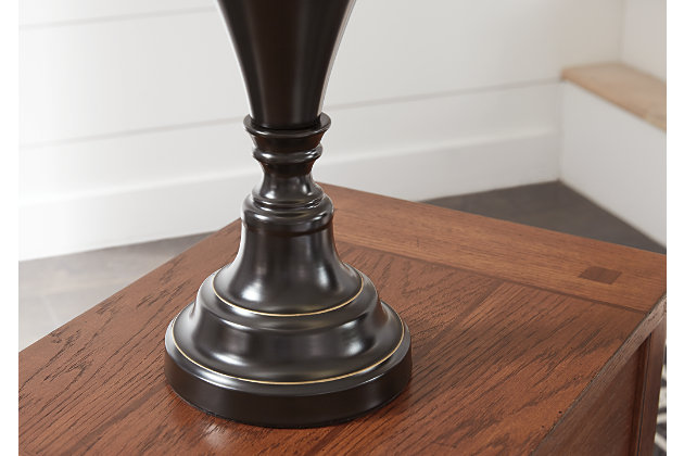 Delightfully turned pedestal base gives the Darlita table lamp a sense of easy elegance. Dark bronze-tone metal is a simply stylish counterpoint.Made of metal with fabric hardback shade | 3-way switch | 1 type A bulb (not included); 150 watts max or CFL 25 watts max; UL Listed | Clean with a soft, dry cloth | Assembly required | Estimated Assembly Time: 15 Minutes