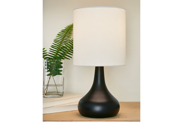 With its sleek metal droplet body, topped with a white drum shade, the Camdale table lamp creates an engaging look. A single USB charging port keeps your electronics up and running at all times. Place this lamp in the living room for a radiant focal point that speaks to the educated eye, or use it in the boudoir for an opulent touch. Made of metal with drum hardback fabric shade | Black finish | USB charging port | On/off switch | 1 E26 socket; type A bulb recommended (not included); 40 watts max or CFL 8 watts max; UL listed | Assembly required | Estimated Assembly Time: 15 Minutes