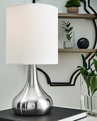 With its sleek metal droplet body, topped with a white drum shade, the Camdale table lamp creates an engaging look. A single USB charging port keeps your electronics up and running at all times. Place this lamp in the living room for a radiant focal point that speaks to the educated eye, or use it in the boudoir for an opulent touch. Made of metal and drum hardback fabric shade | Brushed silvertone finish | USB charging port | On/off switch | 1 E26 socket; type A bulb recommended (not included); 40 watts max or CFL 8 watts max; UL listed | Assembly required