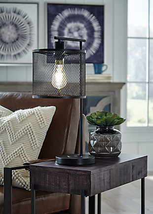 For urban sophistication, add the Nolden desk lamp to your space. A bronze-tone finish and metal shade help this structured lamp shed light on good style.Made of metal with metal drum shade | On-off switch | Wireless and USB charging capabilities | 1 type A bulb (not included); 60 watt max 13 CFL watt max; UL Listed | Assembly required | Estimated Assembly Time: 15 Minutes