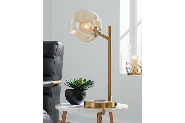The added functionality of the Abanson desk lamp was smartly designed to shine light where you need it most without compromising style. Featuring a wireless charging pad and 1 USB charging port, you can charge up without cords or clutter. The glass shade brings a fresh take on this design making it the ideal lamp for your living room, reading nook or office.Made of metal with glass shade | Sturdy goldtone frame | On/off switch | Wireless charger; 1 USB charging port | 1 type A bulb (not included), 40 watts max or CFL 8 watts max; UL Listed | Assembly required | Estimated Assembly Time: 15 Minutes