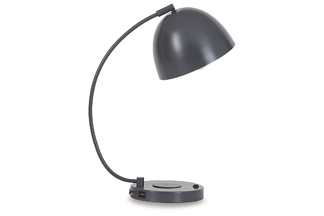 A beautiful accent to your desk, the Austbeck lamp with its adjustable dome shade casts cool shadows as it suspends from a dramatic stem. Featuring a wireless charging pad and 1 USB charging port, you can charge up without cords or clutter. Turn on your decor with this on-trend accent lamp in any space, and give a nod to contemporary style with the flip of a switch.Made of metal with adjustable metal shade | Gray finish | Wireless charger and 1 USB charging port | On/off switch | 1 type G bulb (not included), 40 watts max or CFL 8 watts max; UL Listed | No assembly required