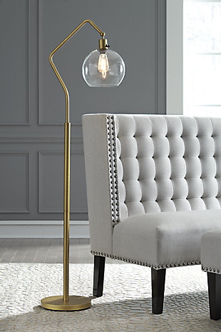 See light through a modern-day lens with the Marilee floor lamp. Antiqued brass-tone finish has the warm, eye-catching aesthetic you love. Glass shade hangs from a beautiful angular arm to illuminate your home.Made of antiqued brass-tone finished metal with glass shade | On/off switch | 1 type A bulb (not included); 60 watts max or CFL 13 watts max; UL Listed | Clean with a soft, dry cloth | Assembly required | Estimated Assembly Time: 15 Minutes