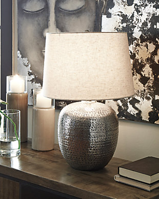 Stay trendy with hammered aluminum that exudes urban refinement. The Magalie table lamp’s silvertone sheen will fill any space with well-lit splendor.Made of antiqued silvertone hammered aluminum with modified drum shade | 3-way switch | 1 type A bulb (not included); 150 watts max or CFL 25 watts max; UL Listed | Clean with a soft, dry cloth | Assembly required | Estimated Assembly Time: 15 Minutes