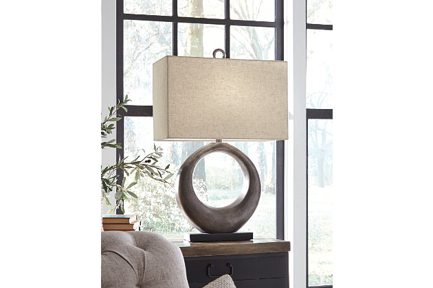 Part sculpture and totally beautiful, the Saria table lamp lets you delight in the art of lighting. The aesthetic may be contemporary and refined, but its antique silvertone cast aluminum infuses a raw element for beautiful balance.Made of cast aluminum with fabric rectangular hardback shade | Antique silvertone finish | 3-way switch | 1 type A bulb (not included); 150 watts max or CFL 25 watts max; UL Listed | Assembly required | Estimated Assembly Time: 15 Minutes