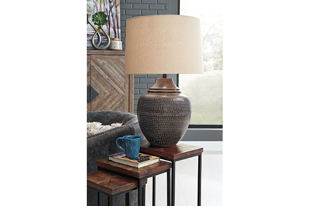 Cast your space in the right light with the Olinger table lamp. The antiqued brown finish adds to the versatile urn shape allowing it to fit seamlessly into a myriad of decor schemes. Even when you decide to redecorate, you will find new uses for this adaptable lamp.Made of antiqued finished metal with modified drum shade | 3-way switch | 1 type A bulb (not included); 150 watts max or 25 CFL watts max; UL Listed | Assembly required | Estimated Assembly Time: 15 Minutes