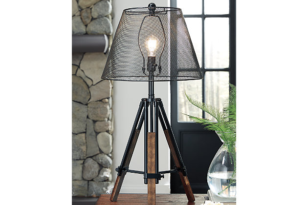 Sporting a snappy tripod base and wire mesh see-through shade, the Leolyn table lamp strikes a pose for casually cool style. Blend of wood and metal makes it all the more interesting. Adjustable height design makes it all the more functional.Made of metal and wood | 3-way switch | 1 type A bulb (not included); 150 watts max or CFL 25 watts max; UL listed | Clean with a soft, dry cloth | Assembly required | Estimated Assembly Time: 15 Minutes