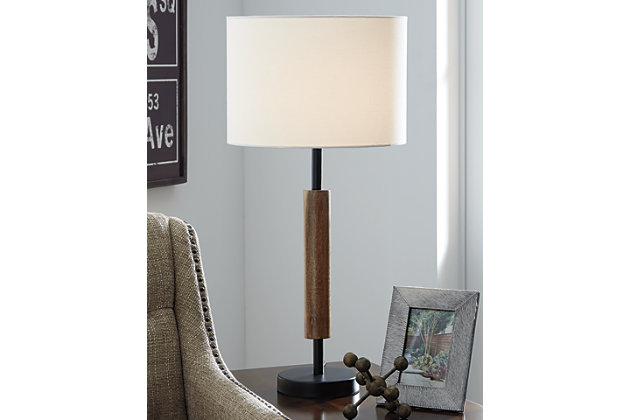 Delight in the sleek minimalism and sheer simplicity of the wood and metal Maliny table lamp. Cylindrical shaping is sure to round out a contemporary space beautifully.Made of metal and wood with fabric drum shade | 3-way switch | 1 type A bulb (not included); 150 watts max or CFL 25 watts max; UL Listed | Assembly required | Clean with a soft, dry cloth | Estimated Assembly Time: 15 Minutes