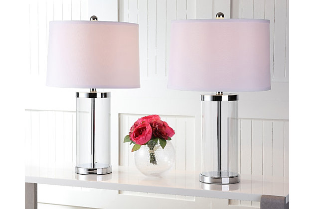Simply sculptural, this table lamp set provides understated illumination that clearly complements transitional and contemporary rooms. A modern drum shade of white linen contrasts mirrored chrome-tone metal.Set of 2 | Made of glass and chrome-tone metal with fabric shade | On/off switch | Cfl bulb; 13-watt bulb included | Wipe with a soft, dry cloth; avoid use of chemicals and household cleaners as they may damage finish | Assembly required