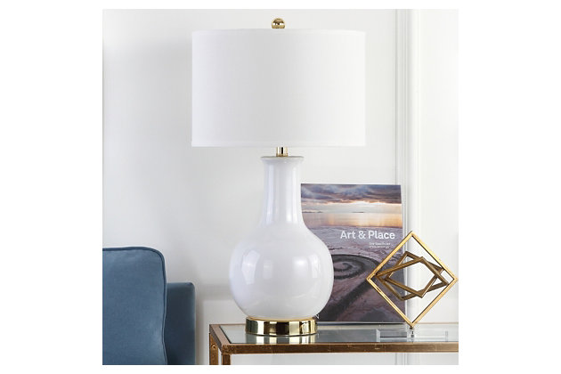 This curvaceous table lamp is sure to illuminate any room with elegance and contemporary flair. Crafted of glazed ceramic, its goregous gourd body is accented with goldtone-finished metal at the neck and base and topped with a hardback drum shade that's simply delightful.Made of ceramic with fabric shade | On/off switch | Cfl bulb; 13-watt bulb included | Wipe with a soft, dry cloth; avoid use of chemicals and household cleaners as they may damage finish | Assembly required