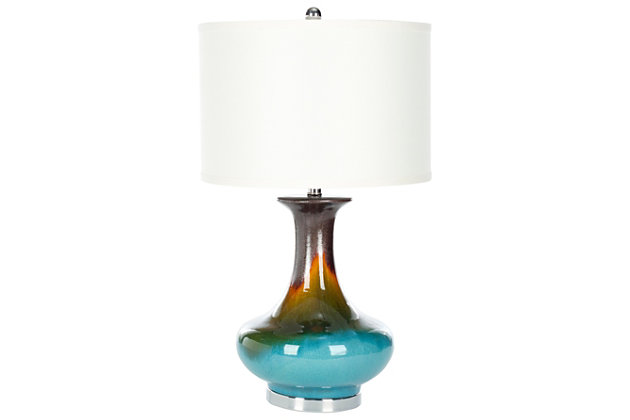 If you dream of Jeannie, then this designer table lamp is your wish granted. Beautifully turned base is crafted of glazed ceramic with an ombre effect and stunning glimmer. Simple off-white cotton hardback drum shade is the perfect topper.Made of ceramic with fabric shade | On/off switch | Cfl bulb; 13-watt bulb included | Wipe with a soft, dry cloth; avoid use of chemicals and household cleaners as they may damage finish | Assembly required