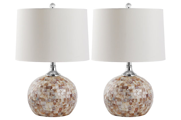 Natural capiz shell table lamp is a study in earthy elegance. Round gourd base is complemented by a simple white drum shade and silvertone metal. You’re sure to love how its casts an elegant glow in transitional, contemporary and coastal chic interiors.Set of 2 | Made of capiz shell and silvertone metal with fabric shade | On/off switch | Cfl bulb; 13-watt bulb included | Wipe with a soft, dry cloth; avoid use of chemicals and household cleaners as they may damage finish | Assembly required