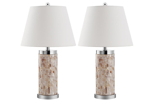 Natural capiz shell table lamp is a study in earthy elegance. Simply chic cylinder base is complemented by a white modified drum shade and silvertone metal. You’re sure to love how its casts an elegant glow in transitional, contemporary and coastal chic interiors.Set of 2 | Made of capiz shell and silvertone metal with fabric shade | On/off switch | Cfl bulb; 13-watt bulb included | Wipe with a soft, dry cloth; avoid use of chemicals and household cleaners as they may damage finish | Assembly required