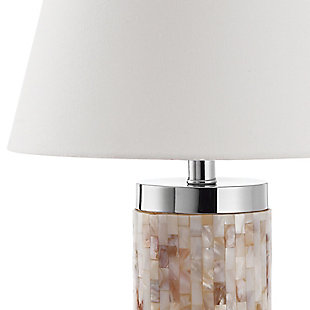 Natural capiz shell table lamp is a study in earthy elegance. Simply chic cylinder base is complemented by a white modified drum shade and silvertone metal. You’re sure to love how its casts an elegant glow in transitional, contemporary and coastal chic interiors.Set of 2 | Made of capiz shell and silvertone metal with fabric shade | On/off switch | Cfl bulb; 13-watt bulb included | Wipe with a soft, dry cloth; avoid use of chemicals and household cleaners as they may damage finish | Assembly required