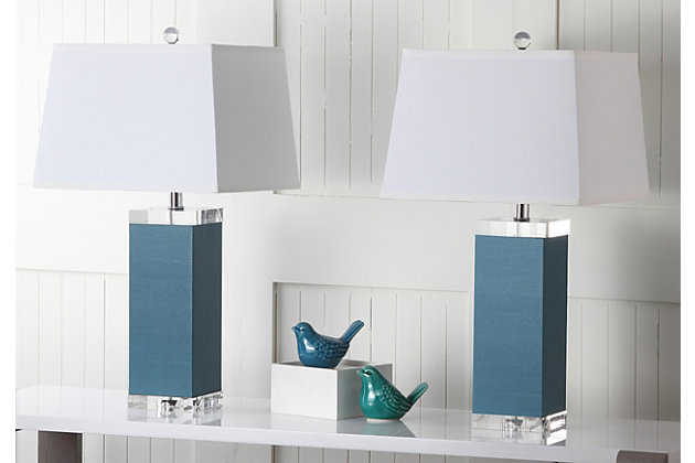 Inspired by a vintage piece perched on the concierge’s desk in one of London's five-star hotels, this table lamp is a modern luxury. An elegant marine blue finish and a faux leather texture make this a tastemaker favorite.Set of 2 | Made of polyurethane and metal with cotton shade | 1 type a bulb (not included); 40 watts max or cfl 13 watts max | Assembly required | Clean with a soft, dry cloth