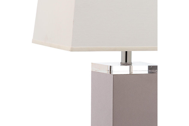 Strong geometric lines and an elegant base imbue the Deco Leather table lamp with timeless Art Deco style.  Crafted with sophisticated grey PU leather with silvertone finial and stand, this classic lamp comes with a rectangular cotton hardback shade.Set of 2 | Made of polyurethane and metal with cotton shade | 1 type a bulb (not included); 40 watts max or cfl 13 watts max | Assembly required | Clean with a soft, dry cloth