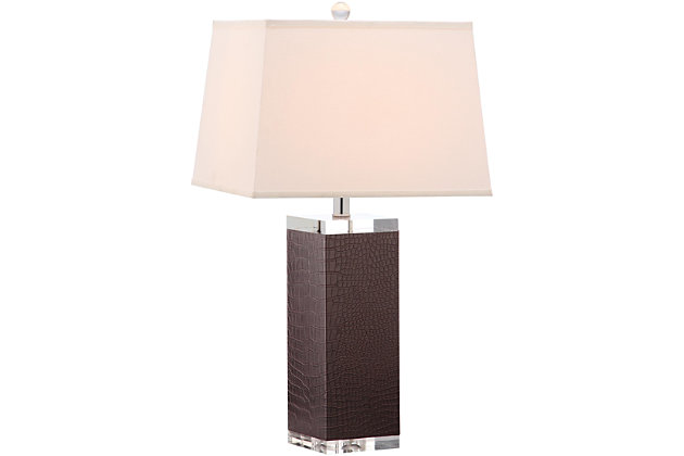 Inspired by a vintage piece perched on the concierge’s desk in one of London's five-star hotels, this table lamp is a modern luxury. An elegant dark brown finish and a faux leather texture make this a tastemaker favorite.Set of 2 | Made of polyurethane and metal with cotton shade | 1 type a bulb (not included); 40 watts max or cfl 13 watts max | Assembly required | Clean with a soft, dry cloth