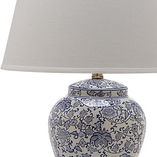 Winding branches bursting with white flower buds adorn this classically styled table lamp. True to its roots in Asian design, this elegant urn-shaped lamp is crafted of ceramic with a fabric drum shade and gilded accents.Set of 2 | Made of ceramic with cotton shade | 1 type a bulb (not included); 40 watts max or cfl 13 watts max | Assembly required | Clean with a soft, dry cloth