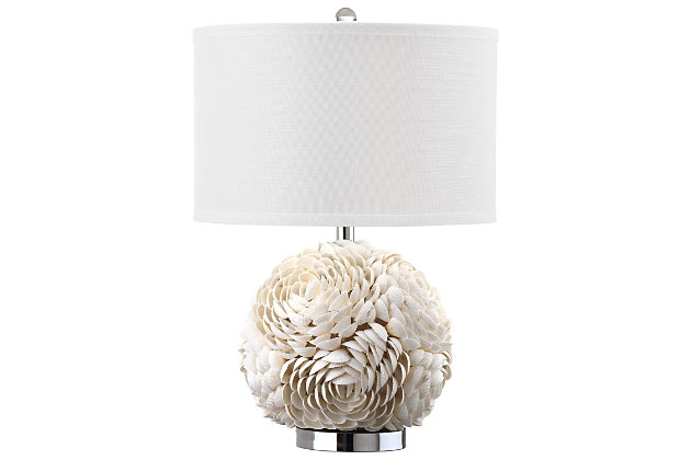 Shell artistry reigns in the distinctive base of this romantic  table lamp.  With large open blossoms crafted of individual seashells, this unique transitional lamp comes with a white textured cotton drum shade, for coastal chic appeal.Made of shell with cotton shade | 1 type a bulb (not included); 40 watts max or cfl 13 watts max | Assembly required | Clean with a soft, dry cloth