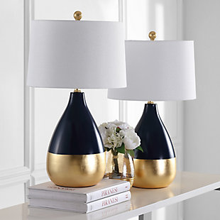 The decadent decor of a London designer’s lush home inspired this navy and goldtone table lamp. Place on either side of a living room armoire for a radiant focal point that speaks to the educated eye or use in the boudoir for an opulent touch.Set of 2 | Made of metal with cotton shade | 1 type a bulb (not included); 40 watts max or cfl 13 watts max | Assembly required | Clean with a soft, dry cloth