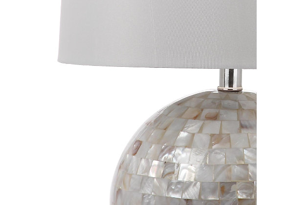 Inspired by the opulent discoveries of ancient pearl divers working in the Mediterranean, this luxurious contemporary shell table lamp is a new-found treasure. Finished in an elegant ivory color, its brilliant shine brings depth and character to any room.Made of shell with fabric shade | 1 type a bulb (not included); 40 watts max or cfl 13 watts max | Assembly required | Clean with a soft, dry cloth