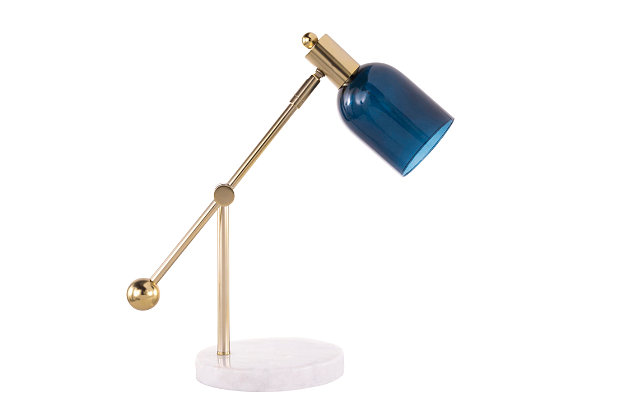 Sophistication never goes out of style. Add a simple, chic accent to your room with this table lamp. With both classic and modern elements, you’ll create an entirely new look that’s all you.Made of glass, steel and marble | Brushed goldtone finish with white marble base and blue glass shade | On/off switch on the base | Requires one 60-watt bulb (not included) | Adjustable height | Indoor use only | Ul listed | Assembly required
