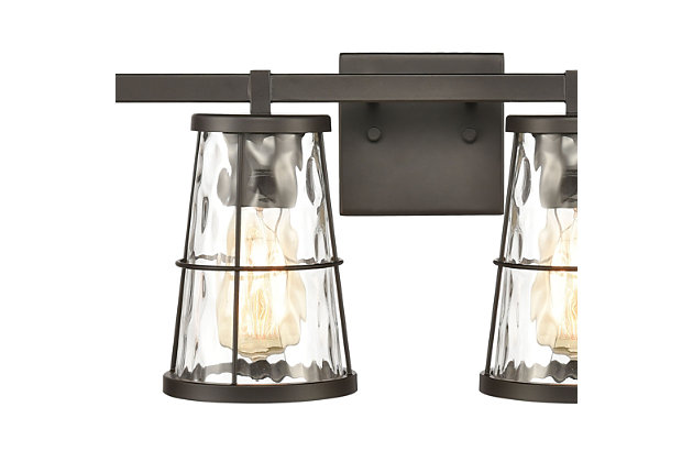Illuminate a space in a farmhouse fresh way with this on-trend vanity light. Quality crafted of sturdy steel, it’s sure to charm with its cage and handle design surrounding water glass. Oil-rubbed bronze-tone finish adds a sense of authenticity.Made of steel and glass | Led compatible | Uses 3 bulbs (60-watt max); not included | Hardwired; professional installation recommended | Assembly required