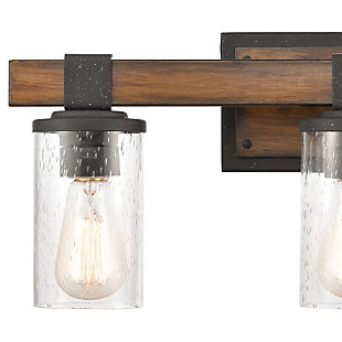 Whether your style is industrial, modern farmhouse or eclectic, delight in the versatility of this vanity light. Features a rustic combination of metalwork and seeded glass cylinders suspended from rugged-loo brackets. Two-tone finish combines a wood look with distressed black for double impact.Made of steel and glass | Led compatible | Uses 3 bulbs (60-watt max); not included | Hardwired; professional installation recommended | Assembly required